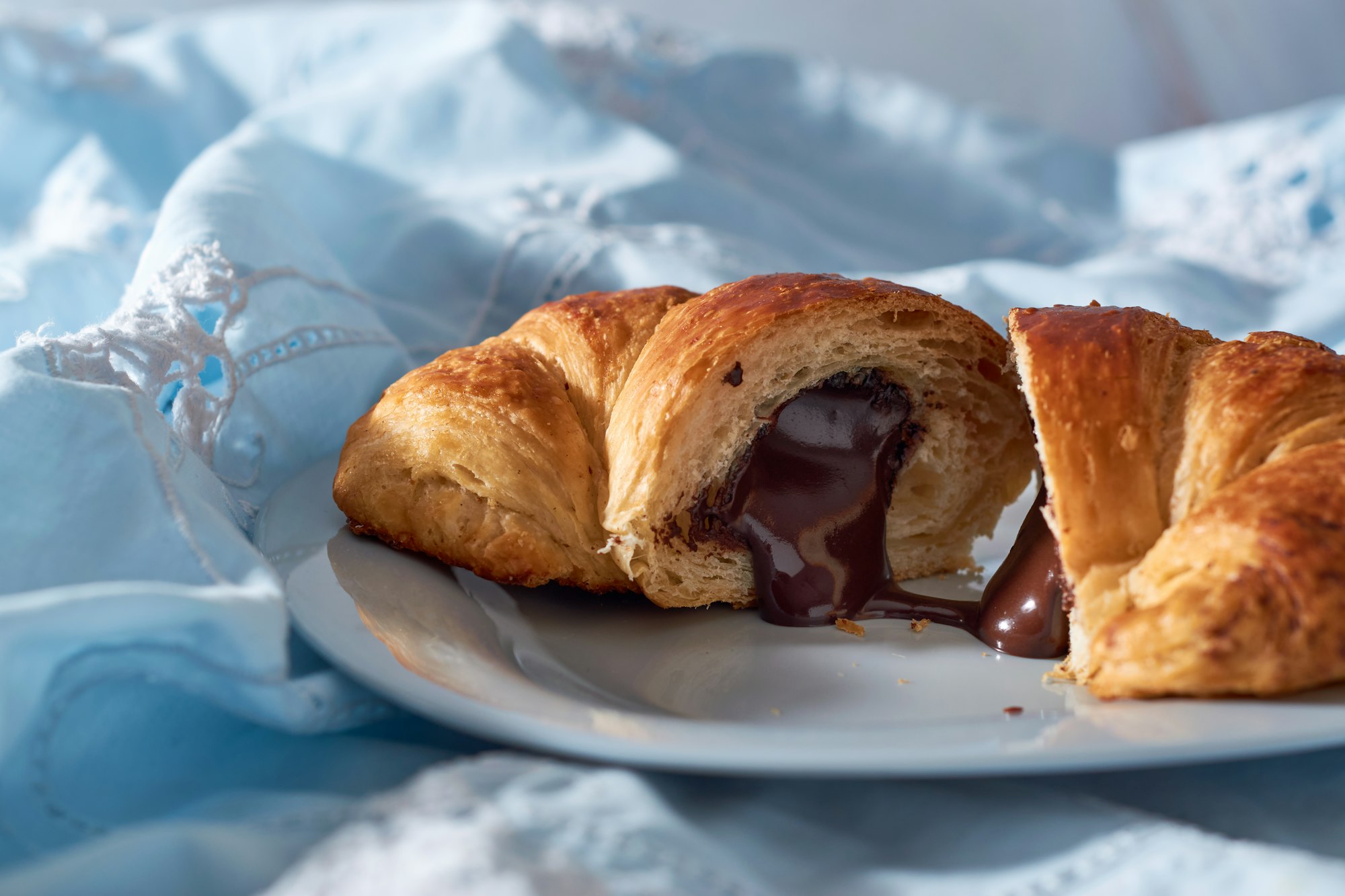 Freshly baked croissant with chocolate close up